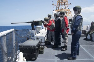 Members of the Dominican Navy participate in .50 cal exercises aboard a USCG Cutter. (Source: USCG)